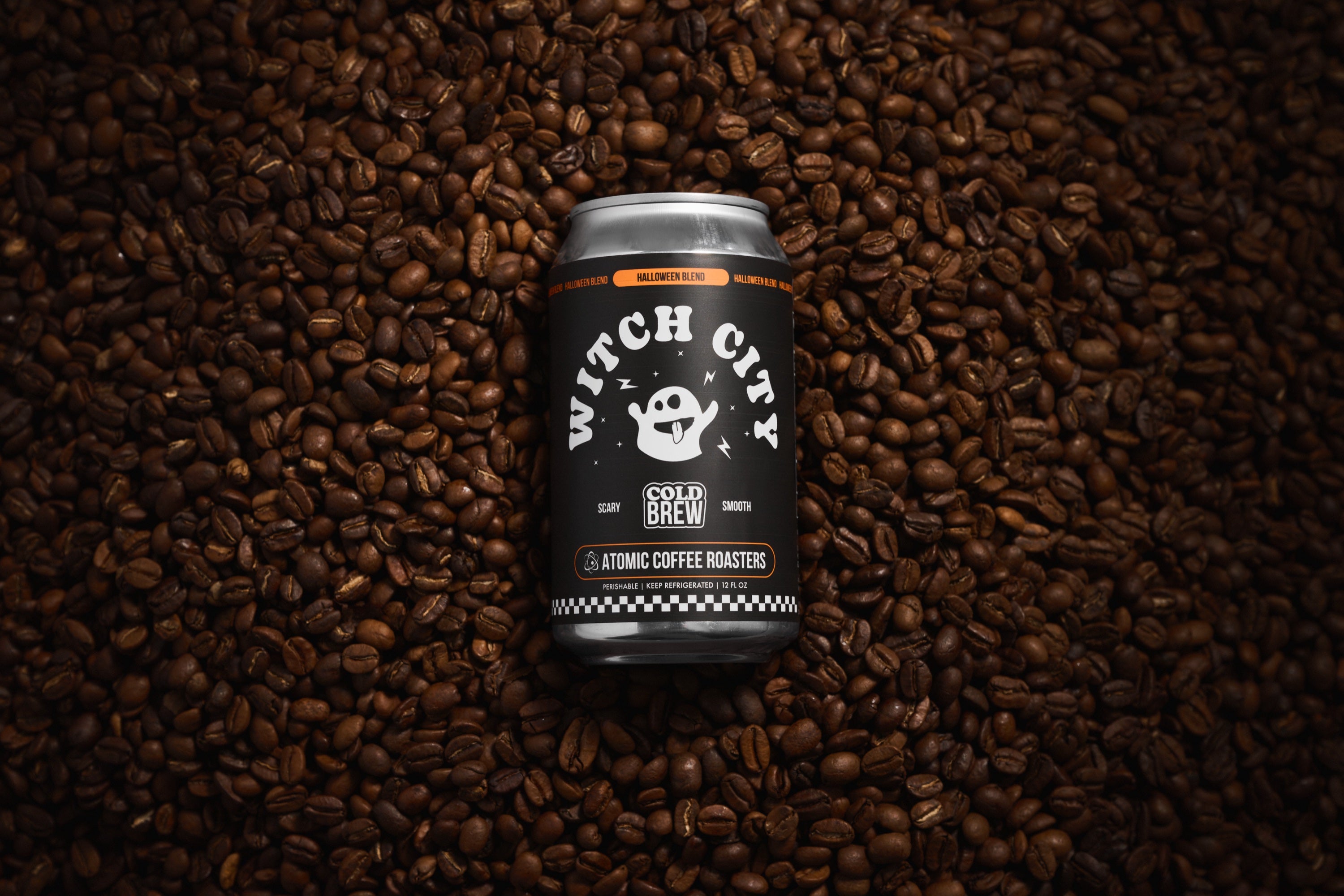 Witch City cold brew can on a bed of coffee beans