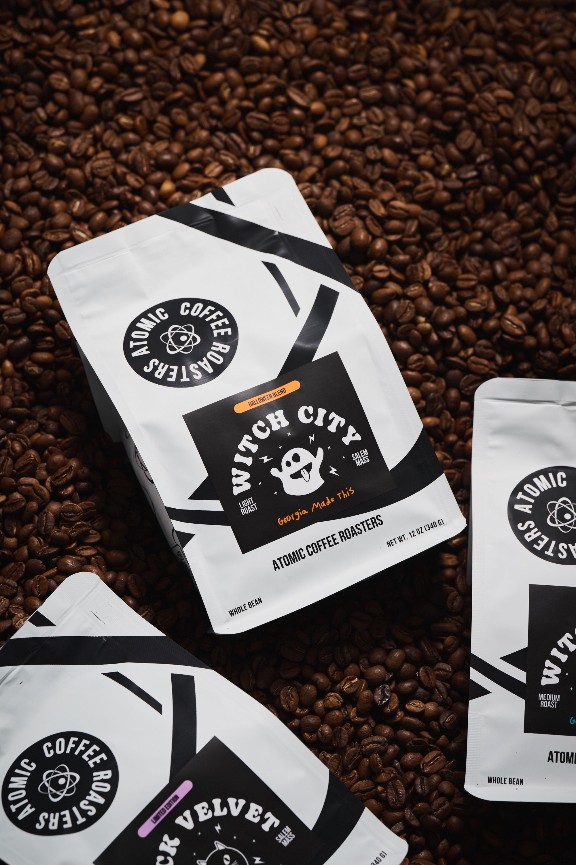 Witch City, Witch House, and Black Velvet bags on a bed of coffee beans