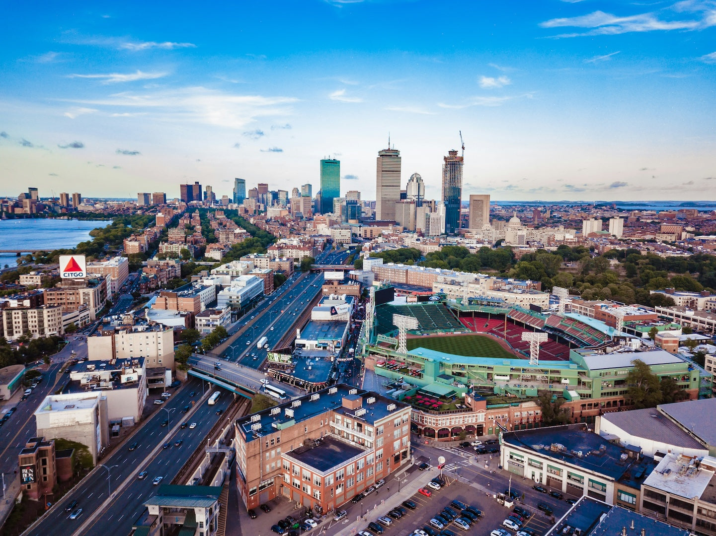Aerial view of a Boston with buildings, roads, and Fenway Park.